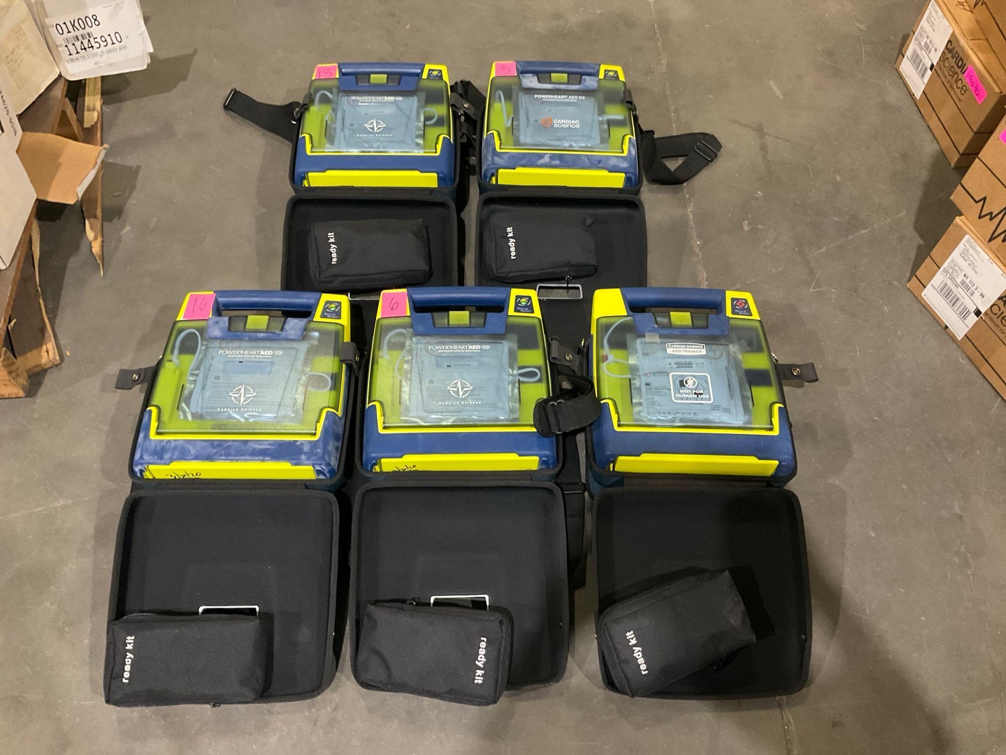 4 CARDIAC SCIENCE AUTOMATED EXTERNAL DEFIBRILLATORS & 1...CARDIAC SCIENCE AED TRAINER