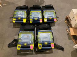 4 CARDIAC SCIENCE AUTOMATED EXTERNAL DEFIBRILLATORS & 1...CARDIAC SCIENCE AED TRAINER