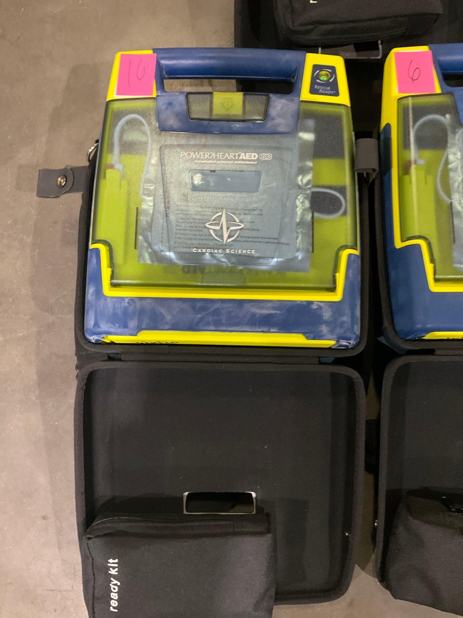 4 CARDIAC SCIENCE AUTOMATED EXTERNAL DEFIBRILLATORS & 1...CARDIAC SCIENCE AED TRAINER