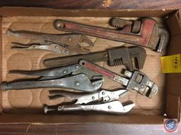 assorted vise grips and pipe wrenches