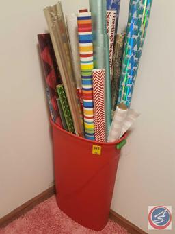 Tall tote containing assorted rolls of Christmas and gift wrap
