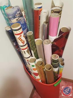 Tall tote containing assorted rolls of Christmas and gift wrap
