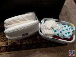 (2) laundry baskets containing pillows, bath linens and pillow cases
