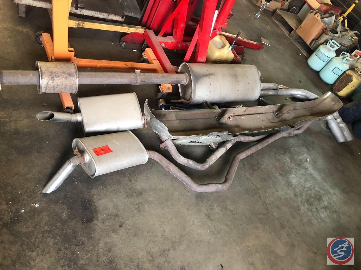 Assorted Mufflers with Exhaust Pipes Attached,