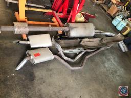 Assorted Mufflers with Exhaust Pipes Attached,