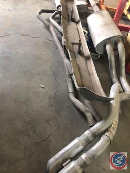 Assorted Mufflers with Exhaust Pipes Attached,