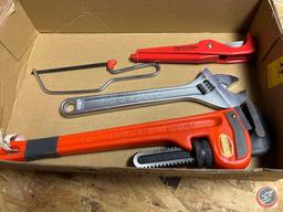 Rigid 18 inch pipe wrench, rigid pipe cutter, 12 inch crescent wrench, small hacksaw