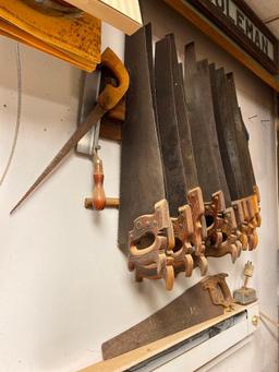 Group of Misc Sized Hand Saws on Garage Wall