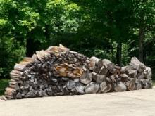 Large Pile of Wooden Boards and Seasoned Logs