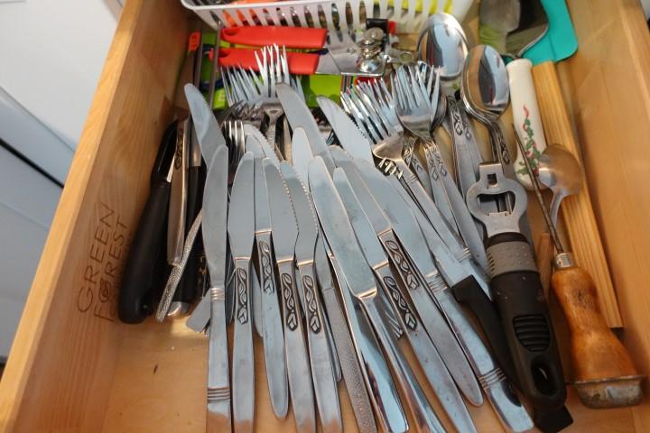 CABINET LOT INCLUDING FLATWARE DRY CONTAINERS COOKWARE AND PLASTIC STORAGE