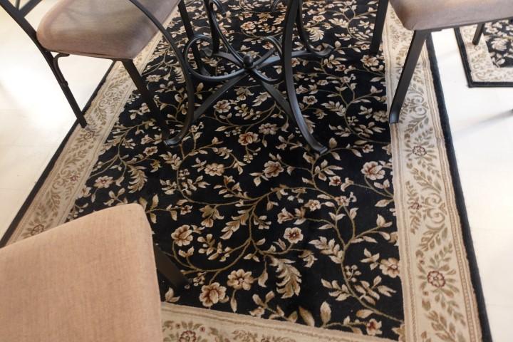 TWO PERSIAN STYLE BLACK RUGS APPROX 5 X 7 AND 5 X 4
