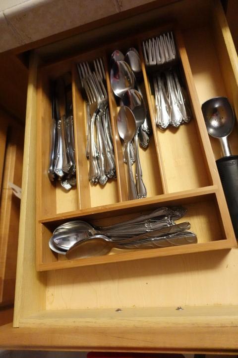 CONTENTS OF TWO DRAWERS AND TWO CABINETS FLATWARE LINENS POTS AND PANS