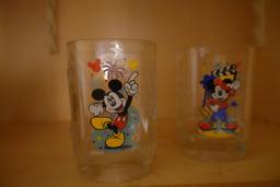 CONTENTS OF CABINET INCLUDING MICKEY MOUSE GLASSES PEDESTAL CAKE DISH FISH