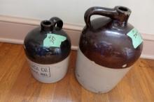 TWO ANTIQUE SALT GLAZE WHISKEY JUGS 1 AND 2 GALLON ONE HAS THE TRIACA CO BA