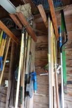 LOT OF TOOLS INCLUDING RAKES SHOVELS PICK AXES GAS PUMP NOZZLES CAULKING GU