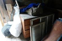FIRST ROW IN BARN INCLUDING BUGGY BENCH COAL STOVE WOODEN BARRELS MISC FURN