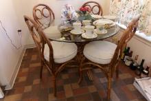 GLASS TOP TABLE WITH RATTAN BASE AND 4 MATCHING CHAIRS