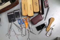 Shoe polishing brushes, scissors, vintage electric razors, and a Waterpik flosser, new in box