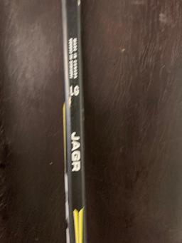 Pair of Logic skis one Traverse mountain ski and a hockey stick