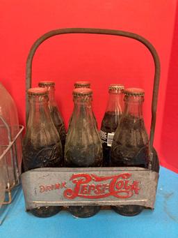 Vintage milk bottles in carrier and vintage Pepsi carrier with Coke bottles