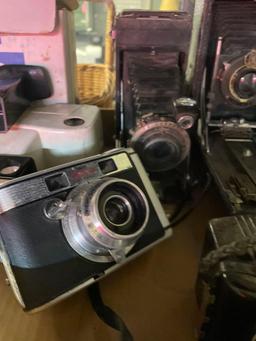 five vintage cameras, Kodak Polaroid video light