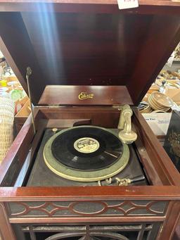 working in Edison manual record player/ photograph with records