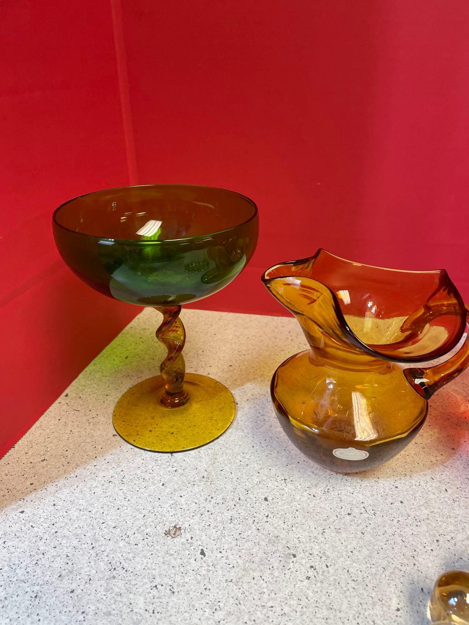 Colorful glassware, including Amberina, LE Smith, moon and stars, green hobnail and Amber vase and