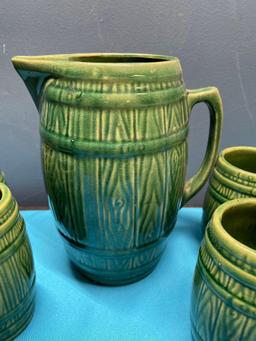 McCoy stoneware pottery pitcher and six mucks