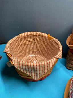 Five Longaberger baskets and one country woven basket