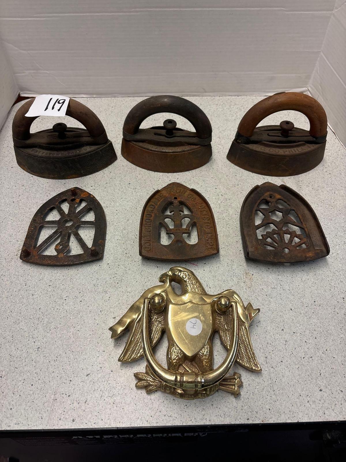 3 sad irons, iron rests and a brass eagle door knocker
