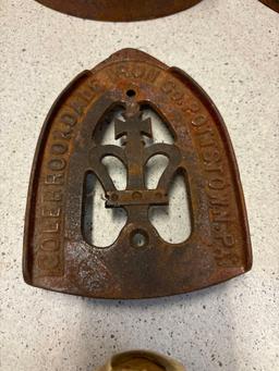 3 sad irons, iron rests and a brass eagle door knocker