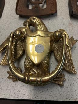 3 sad irons, iron rests and a brass eagle door knocker