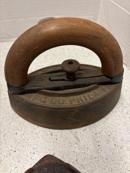 3 sad irons, iron rests and a brass eagle door knocker