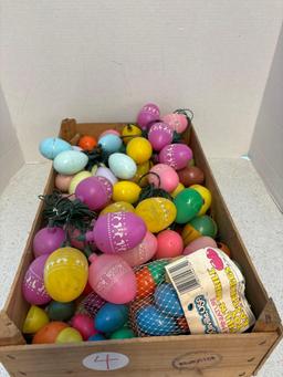 Crate full of plastic Easter eggs, Some are lights