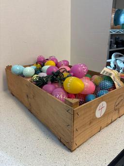Crate full of plastic Easter eggs, Some are lights