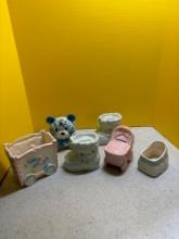 Box full of baby themed, porcelain banks and planters