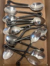 16 large spoons with black curled handles