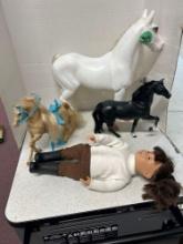 three plastic horses, and doll