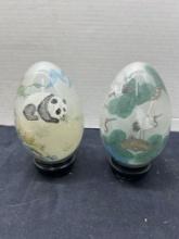 pair of reverse painted large Asian eggs on wooden stands