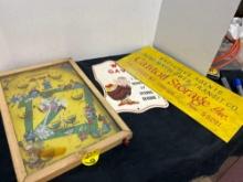 antique tabletop pinball game and cardboard signs