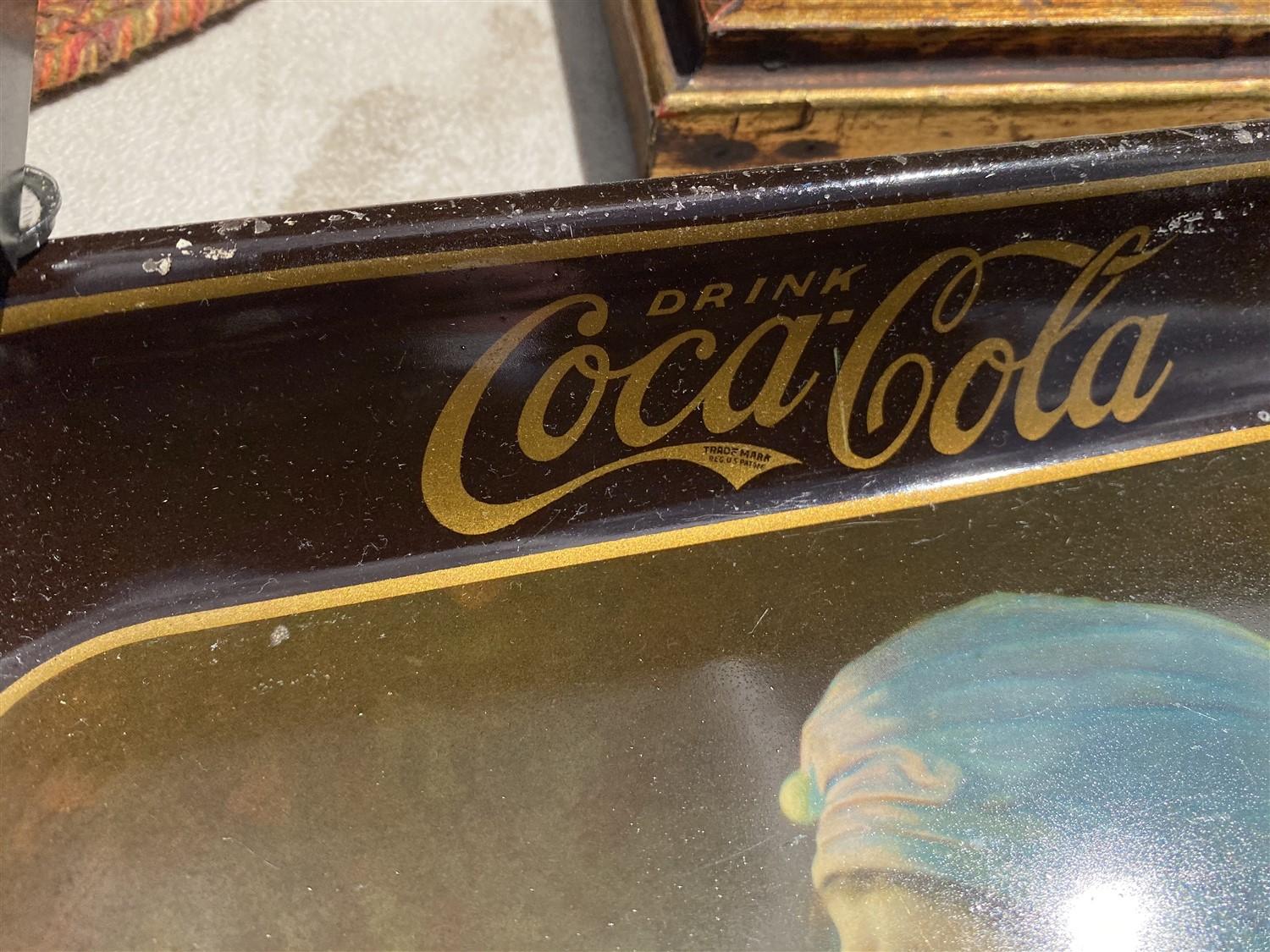 Table lot of assorted framed art, Coca Cola trays, paintings