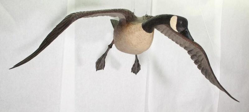 full size, life like Ted Hanks 1978 wood carved Canadian Goose in flight