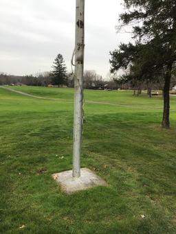 Large flag pole cemented in ground. Buyer responsible for removal