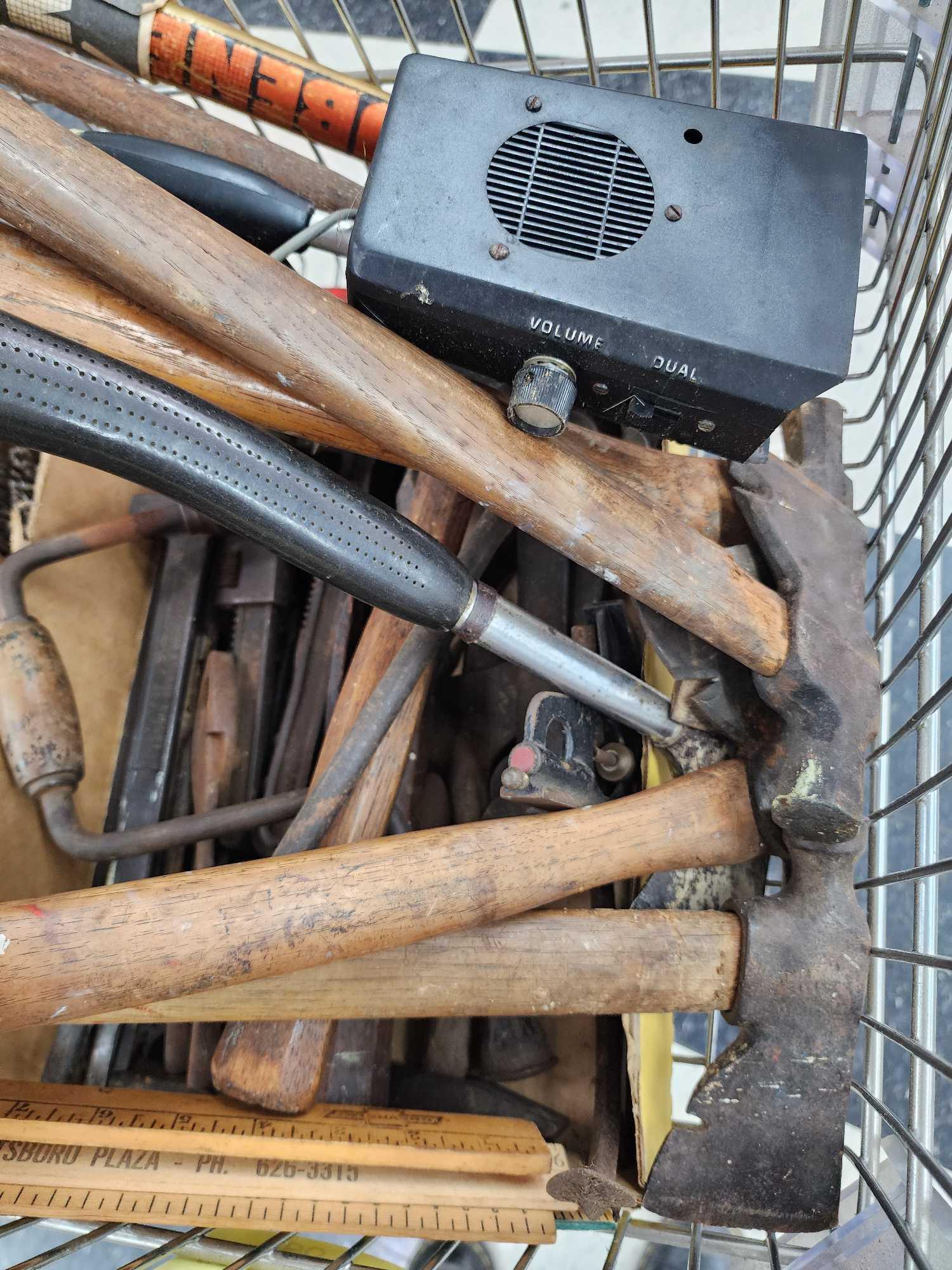 Cart full of vintage tools: hatchets, saws, wrenches, metal detector