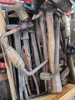 Cart full of vintage tools: hatchets, saws, wrenches, metal detector