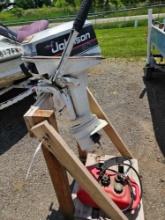 2 Stroke Johnson 8hp boat motor with gas tank, fuel line, and stand