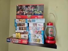 Assortment of Puzzles, Wooden Ohio State Lamp, Offbrand Lego Cars, & Corvette Books