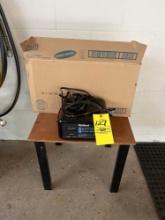 Die Hard battery charger with a side table and paper towels