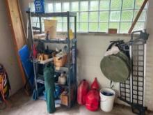 Shelf with tools, gas cans, hosing, car ramps