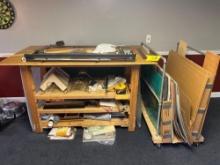Blueprint table with a storage cart and miscellaneous items
